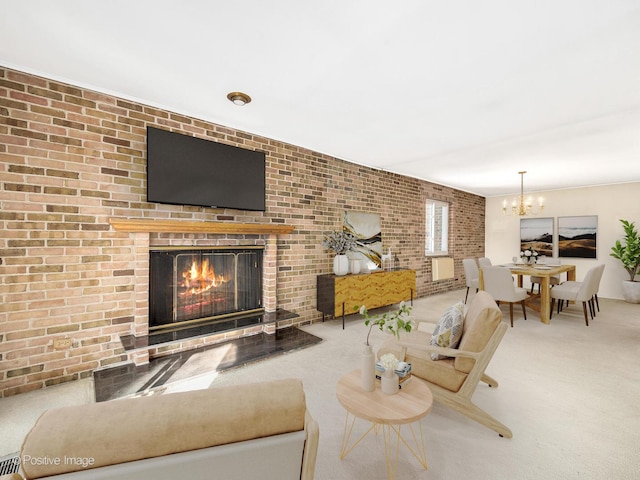 living room featuring a fireplace, brick wall, carpet flooring, and a chandelier