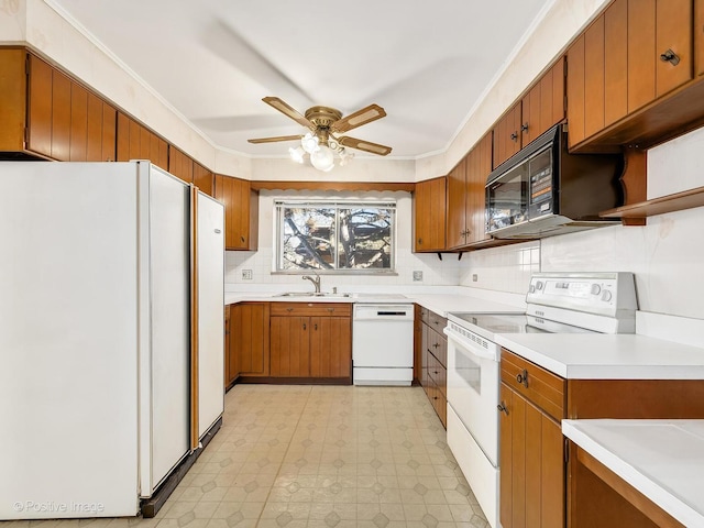 kitchen featuring tasteful backsplash, sink, ornamental molding, ceiling fan, and white appliances