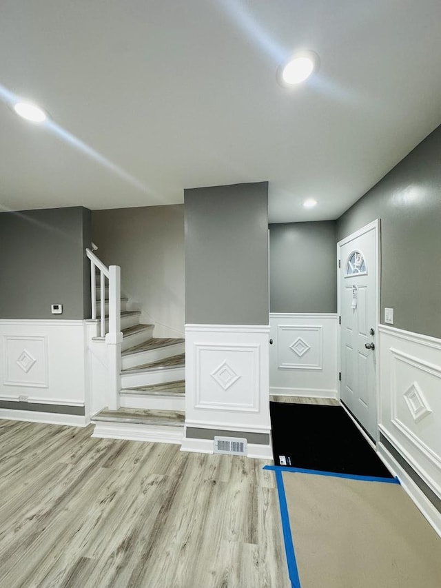 foyer entrance with hardwood / wood-style floors