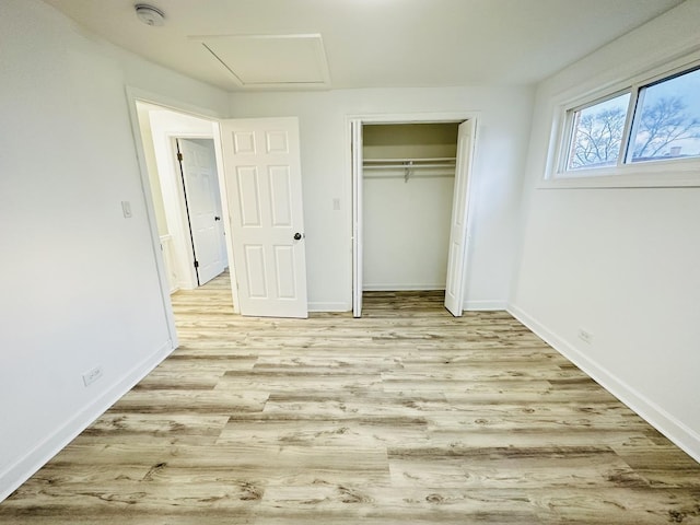 unfurnished bedroom with light hardwood / wood-style floors and a closet