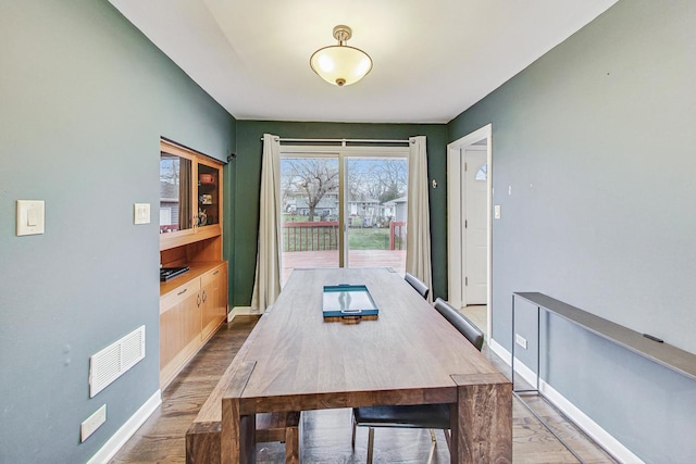 dining space with light hardwood / wood-style floors