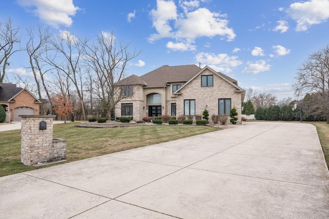 french country style house with a front yard