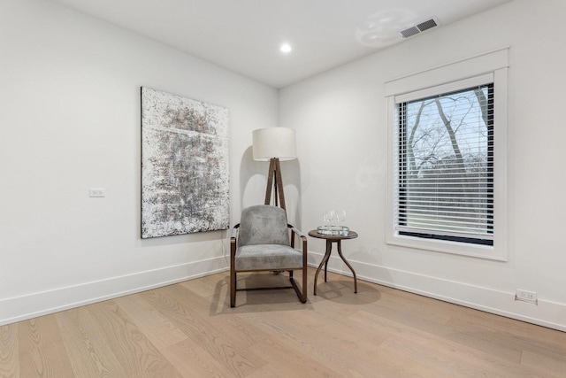 sitting room featuring light hardwood / wood-style floors