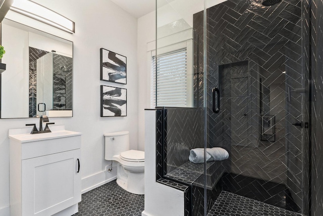 bathroom with tile patterned floors, vanity, toilet, and an enclosed shower