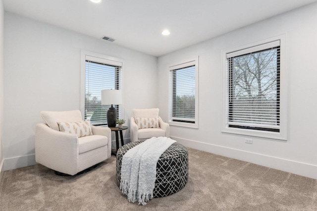 living area with light carpet