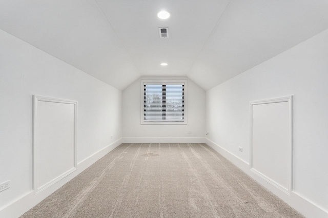 bonus room with carpet and vaulted ceiling