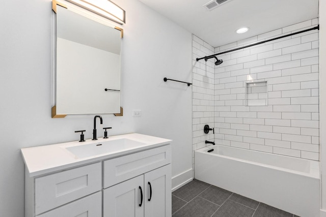 bathroom featuring tile patterned floors, vanity, and tiled shower / bath combo