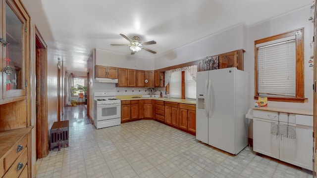 7549 W 62nd St, Summit, IL 60501 - kitchen with white appliances, light floors, under cabinet range hood, and ceiling fan