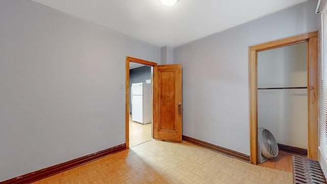7549 W 62nd St, Summit, IL 60501 - unfurnished bedroom with a closet, freestanding refrigerator, and baseboards