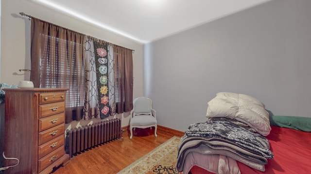 7549 W 62nd St, Summit, IL 60501 - bedroom with baseboards, radiator, and wood finished floors