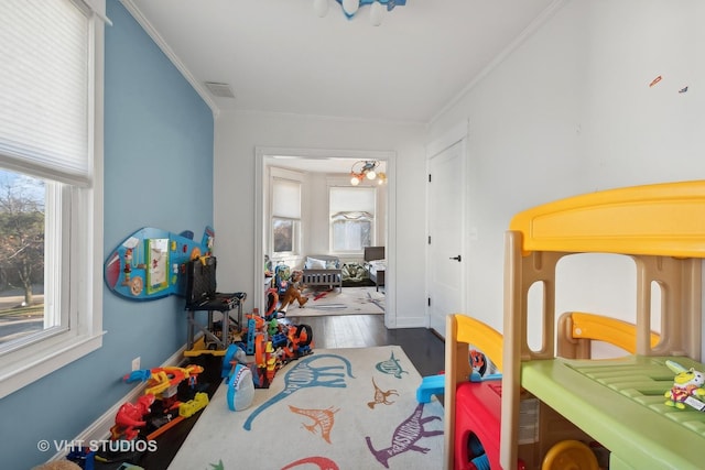 playroom featuring dark hardwood / wood-style floors and crown molding