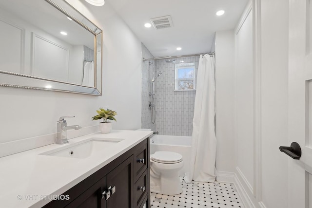 full bathroom with vanity, shower / bath combination with curtain, and toilet