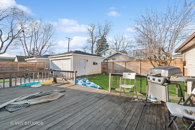 wooden terrace with an outbuilding, a yard, a garage, and grilling area