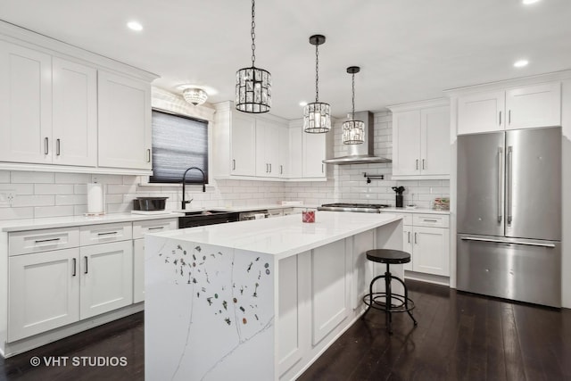 kitchen with stainless steel fridge and white cabinetry