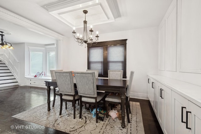 dining room with a chandelier, dark hardwood / wood-style floors, and a tray ceiling