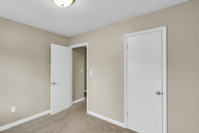 unfurnished bedroom featuring light carpet