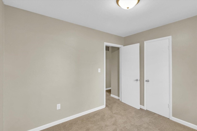 unfurnished bedroom with light carpet