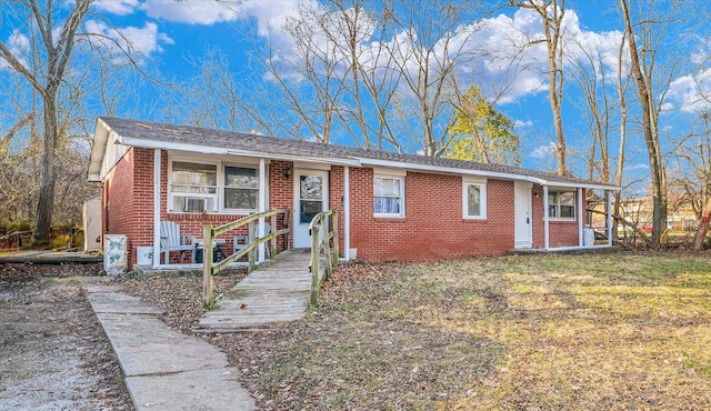 view of front of property with cooling unit and a front yard