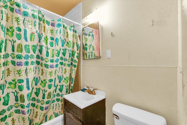 bathroom with toilet, vanity, and walk in shower