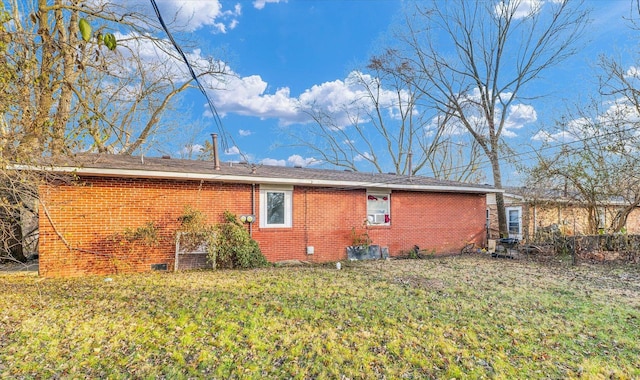 view of side of home with a lawn