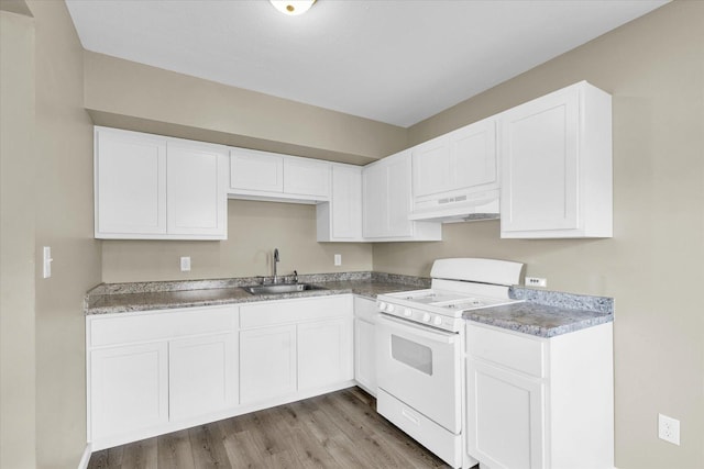 kitchen with custom exhaust hood, white cabinetry, and white stove