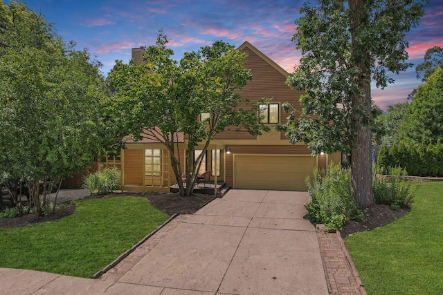 view of front of house with a yard and a garage