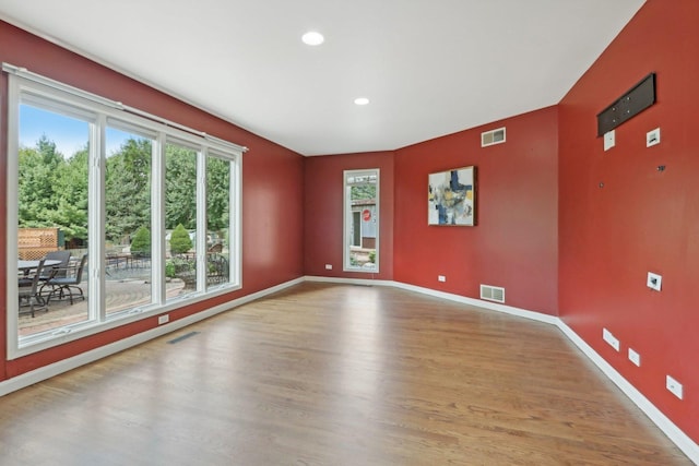 unfurnished room with wood-type flooring