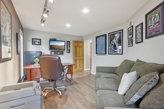 home office featuring rail lighting and light wood-type flooring