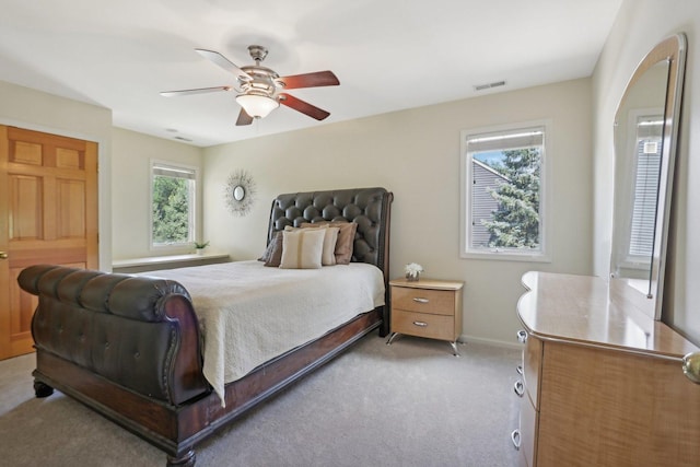 bedroom with ceiling fan and light carpet