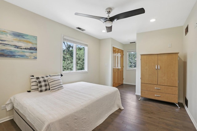 bedroom with ceiling fan and dark hardwood / wood-style flooring