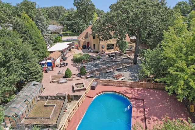 view of swimming pool with a deck and an outbuilding