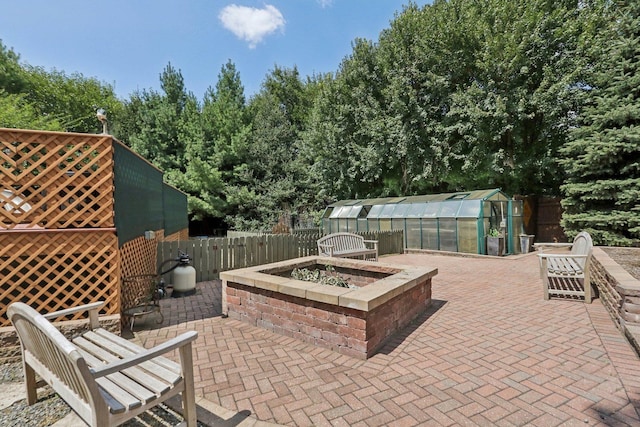 view of patio with an outdoor fire pit and an outdoor structure