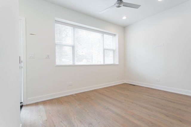 empty room with a ceiling fan, baseboards, and wood finished floors