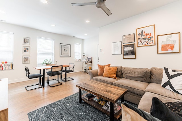 living room featuring recessed lighting, ceiling fan, light wood-style flooring, and baseboards