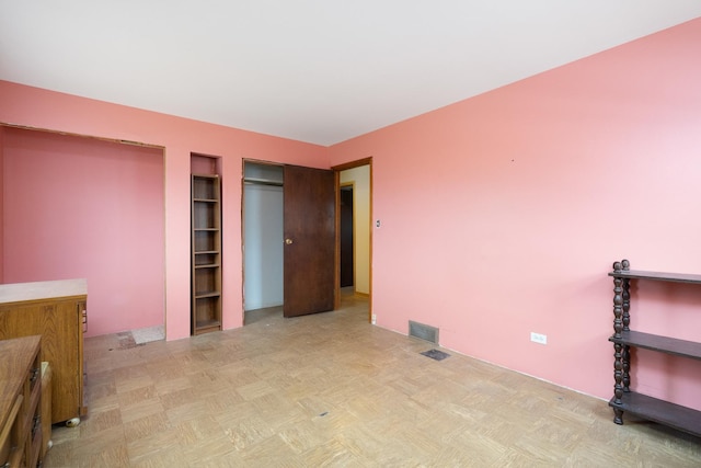 unfurnished bedroom featuring light parquet floors