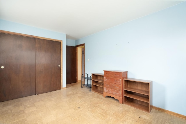 bedroom with light parquet flooring and a closet