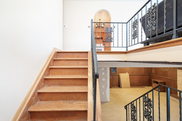 stairs with a chandelier