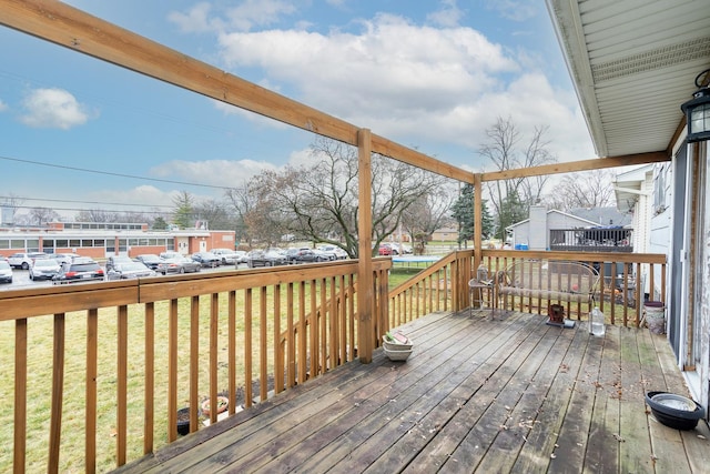 wooden terrace featuring a yard