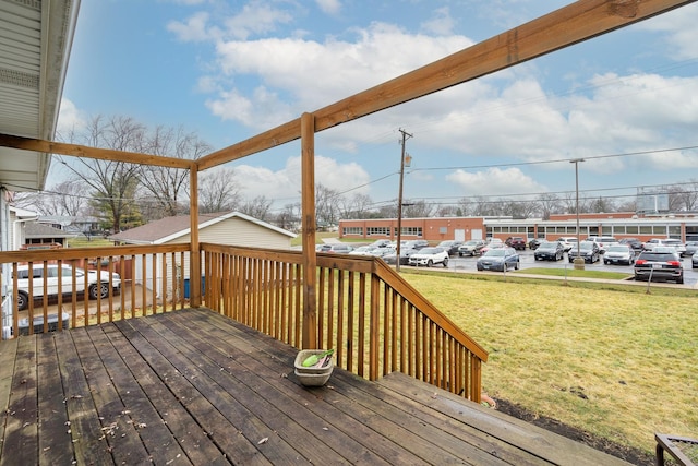 wooden deck featuring a yard