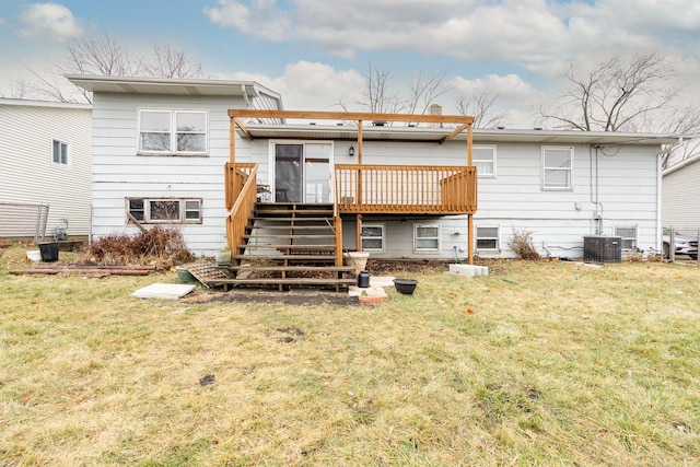 rear view of property featuring central AC, a deck, and a lawn