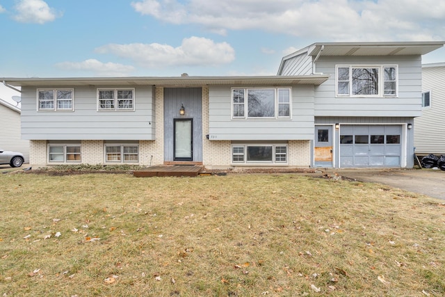 split foyer home with a garage and a front lawn