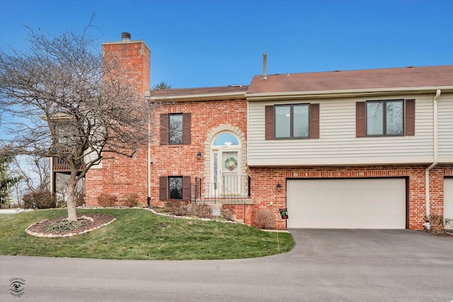 view of front of home with a garage and a front lawn