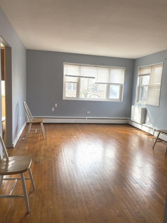 unfurnished room with hardwood / wood-style floors