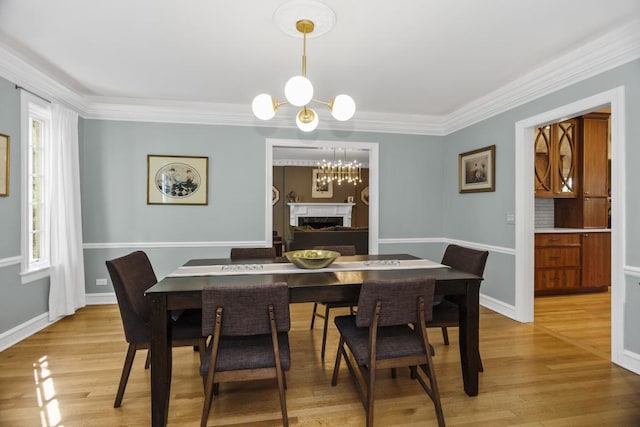 dining room with crown molding, wood-type flooring, and a notable chandelier