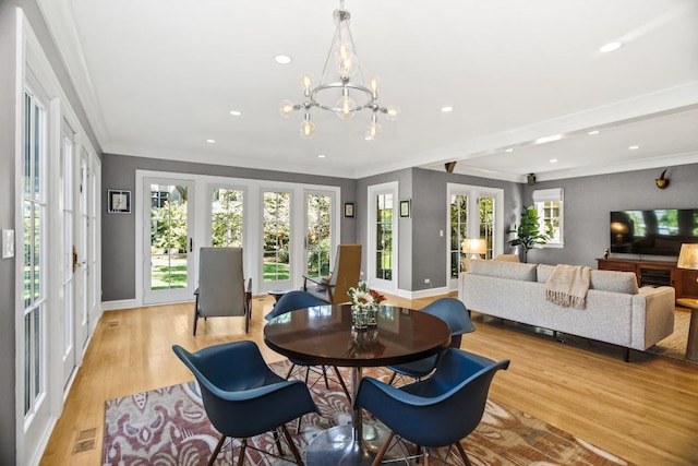 dining room featuring crown molding and light wood-type flooring