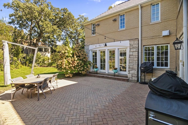 view of patio featuring french doors and a grill