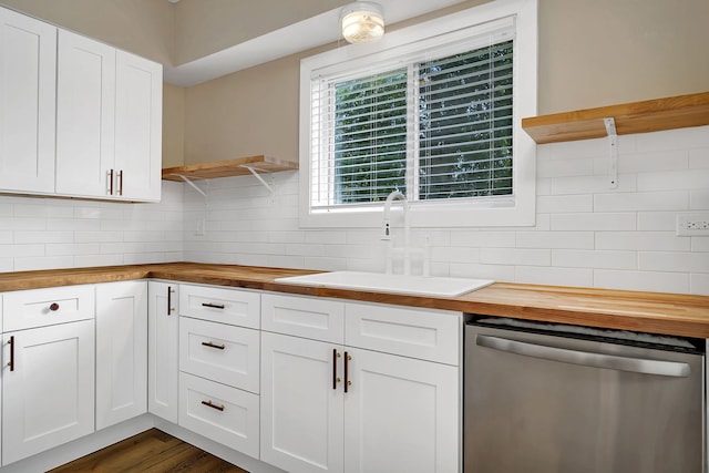 kitchen featuring wooden counters, white cabinetry, dishwasher, and sink