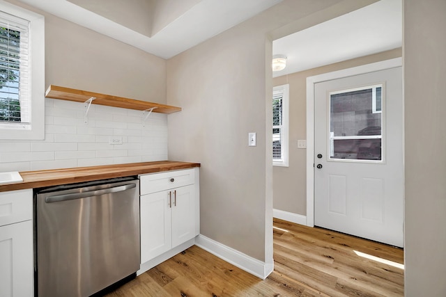 kitchen with white cabinets, dishwasher, light wood-type flooring, and butcher block counters