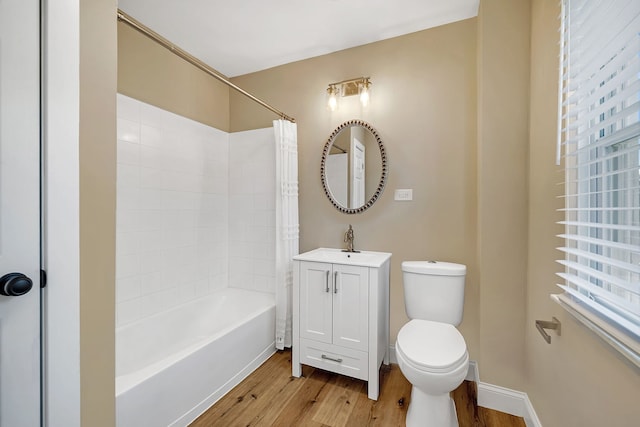 full bathroom featuring hardwood / wood-style floors, vanity, toilet, and shower / bath combo