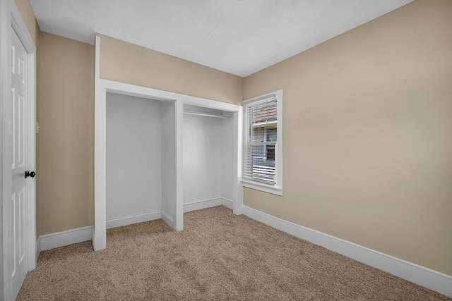 unfurnished bedroom with light colored carpet